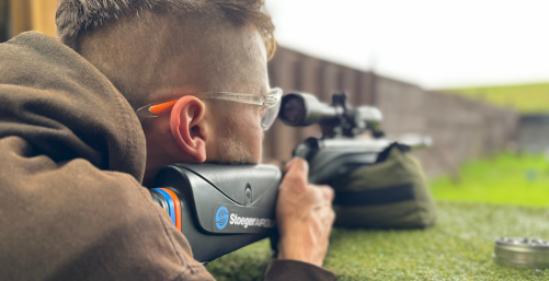 Shooter aiming air rifle with scope