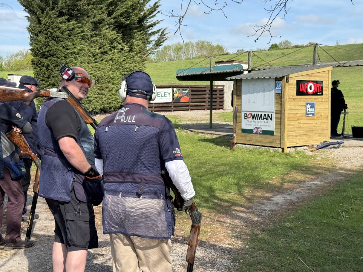 Clay pigeon shooters with shotguns at the North of England Clay Target Centre shooting ground